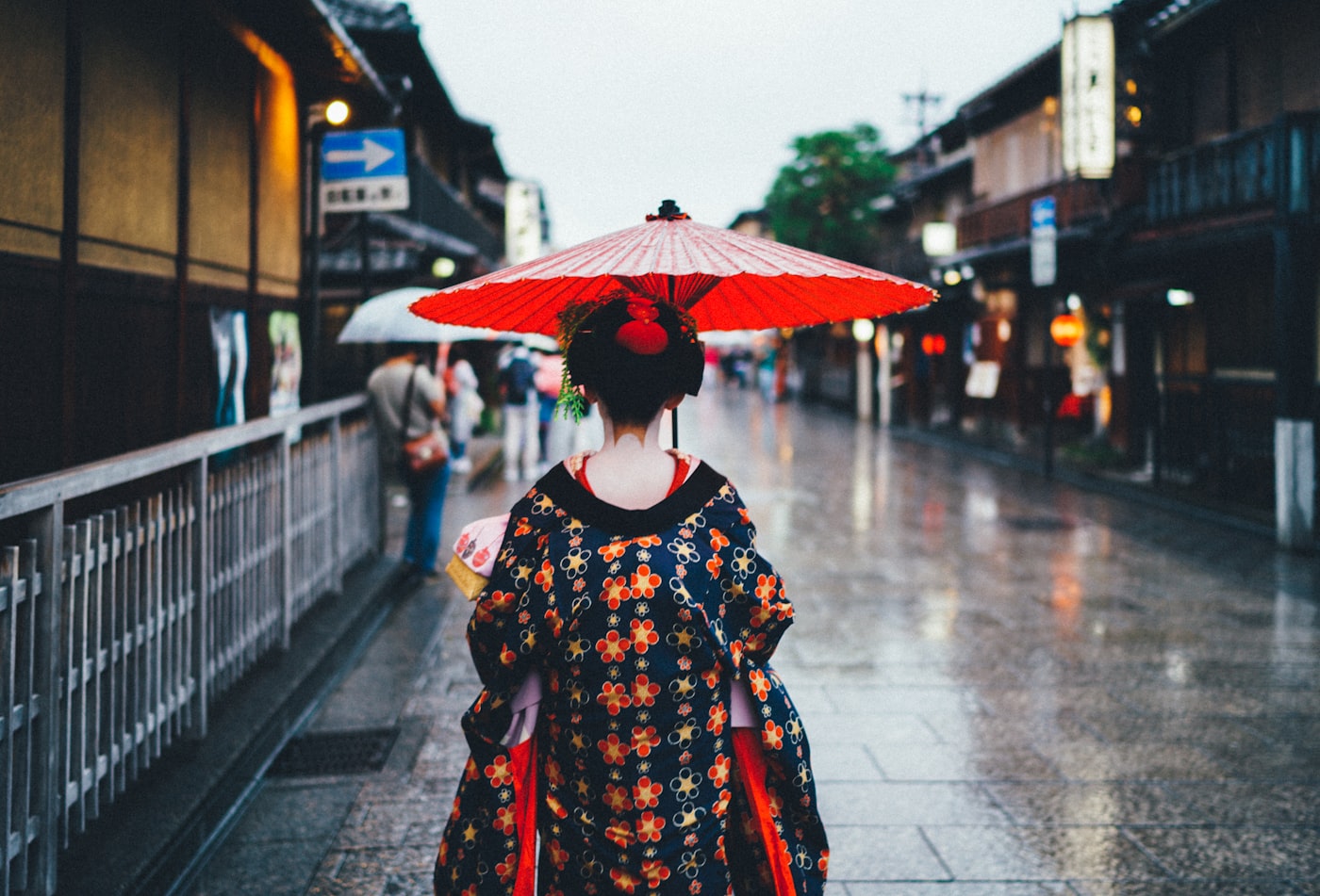 Geiko in kimono with a traditional oil-paper umbrella on a Gion street