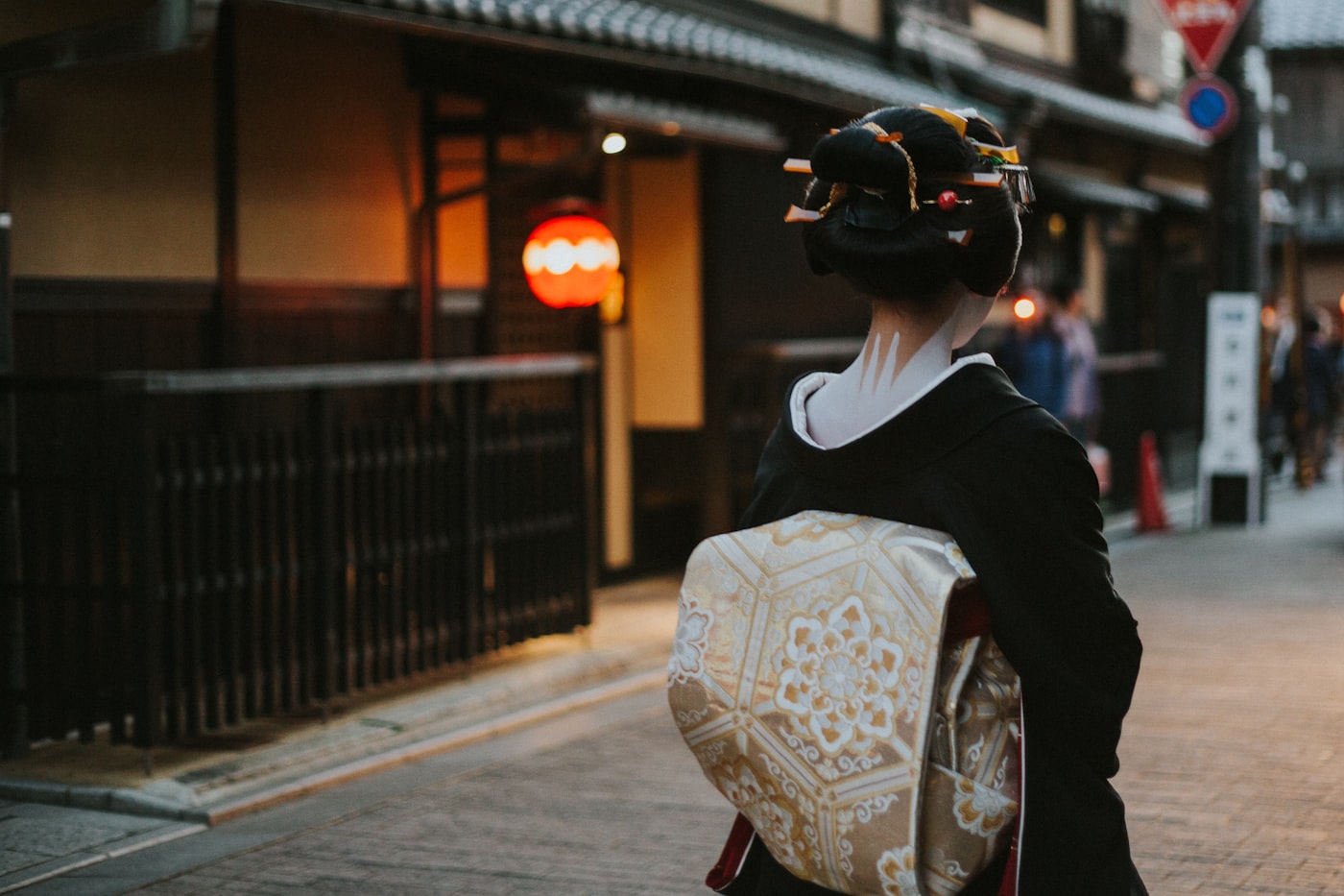 Woman in kimono walking along a traditional Kyoto street