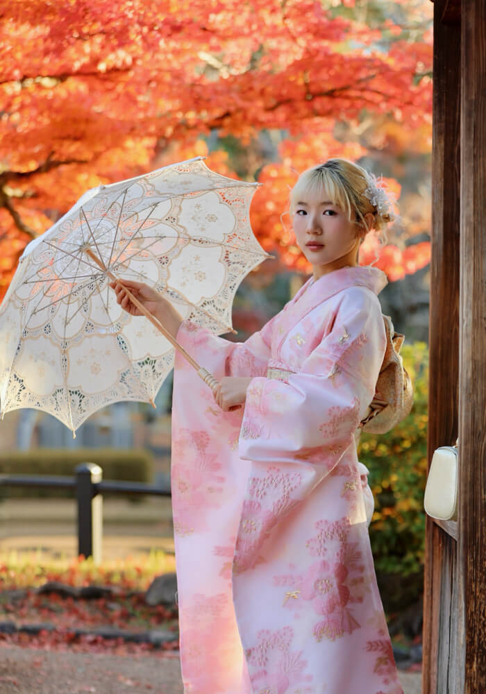 Woman in beautiful floral kimono enjoying a traditional matcha tea ceremony in Kyoto