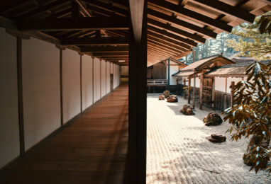 Zen Buddhist monk meditating in Kyoto rock garden