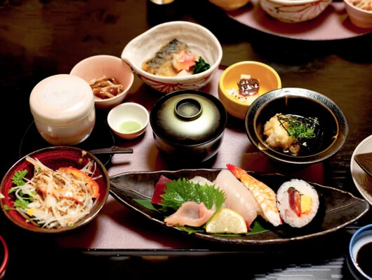 Beautifully plated Japanese Kaiseki Ryori haute cuisine with seasonal garnishes