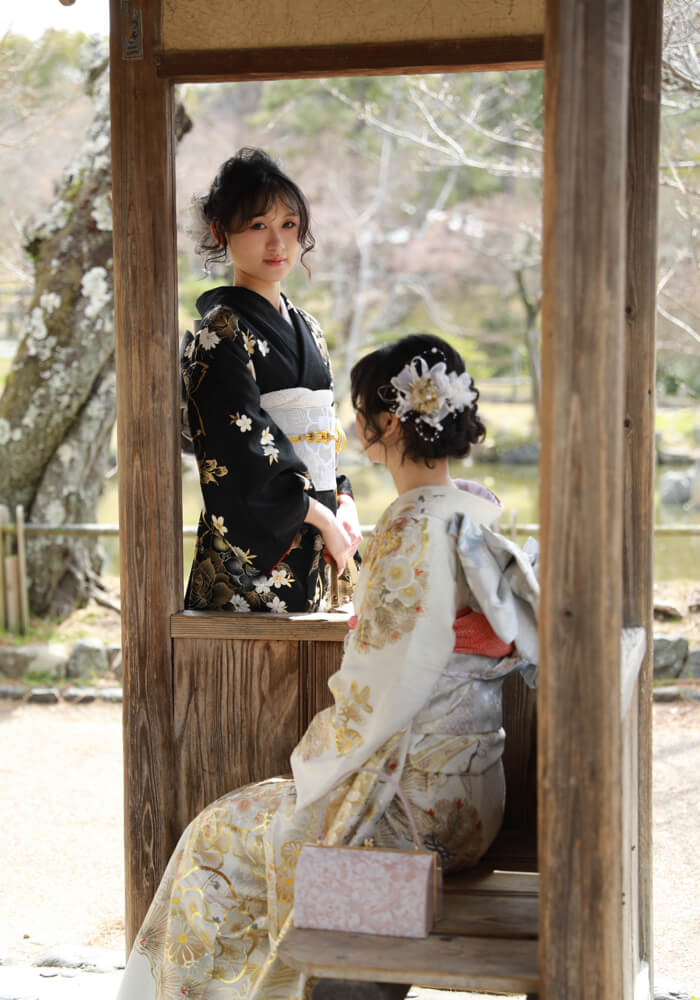Visitor in traditional kimono admiring the panoramic view from Kiyomizu-dera Temple wooden stage in autumn
