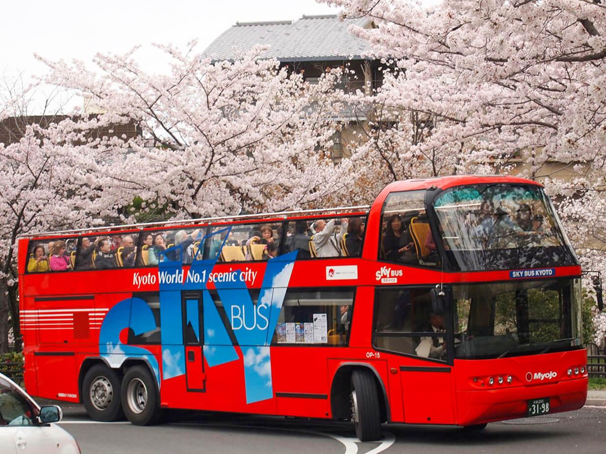 Kyoto green city bus driving through heavy rain during Tsuyu season